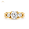 Front view of three-stone cushion-cut ring in silver with a yellow gold-tone rhodium-plated finish