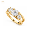 Three-quarter view of cushion-cut three-stone silver ring with yellow gold-tone plating
